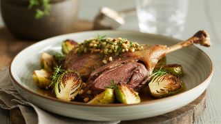 Slow-Roasted Duck Leg Confit with Thyme-Roasted Brussels Sprouts and Hazelnut Gremolata