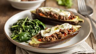 Roasted Eggplant Boats with Spiced Beef and Goat Cheese with Sautéed Garlic Spinach